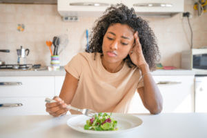 woman feeling hungry eating poor calories food for diet