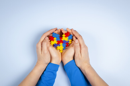 A child's hand full with toys & holding by counselor