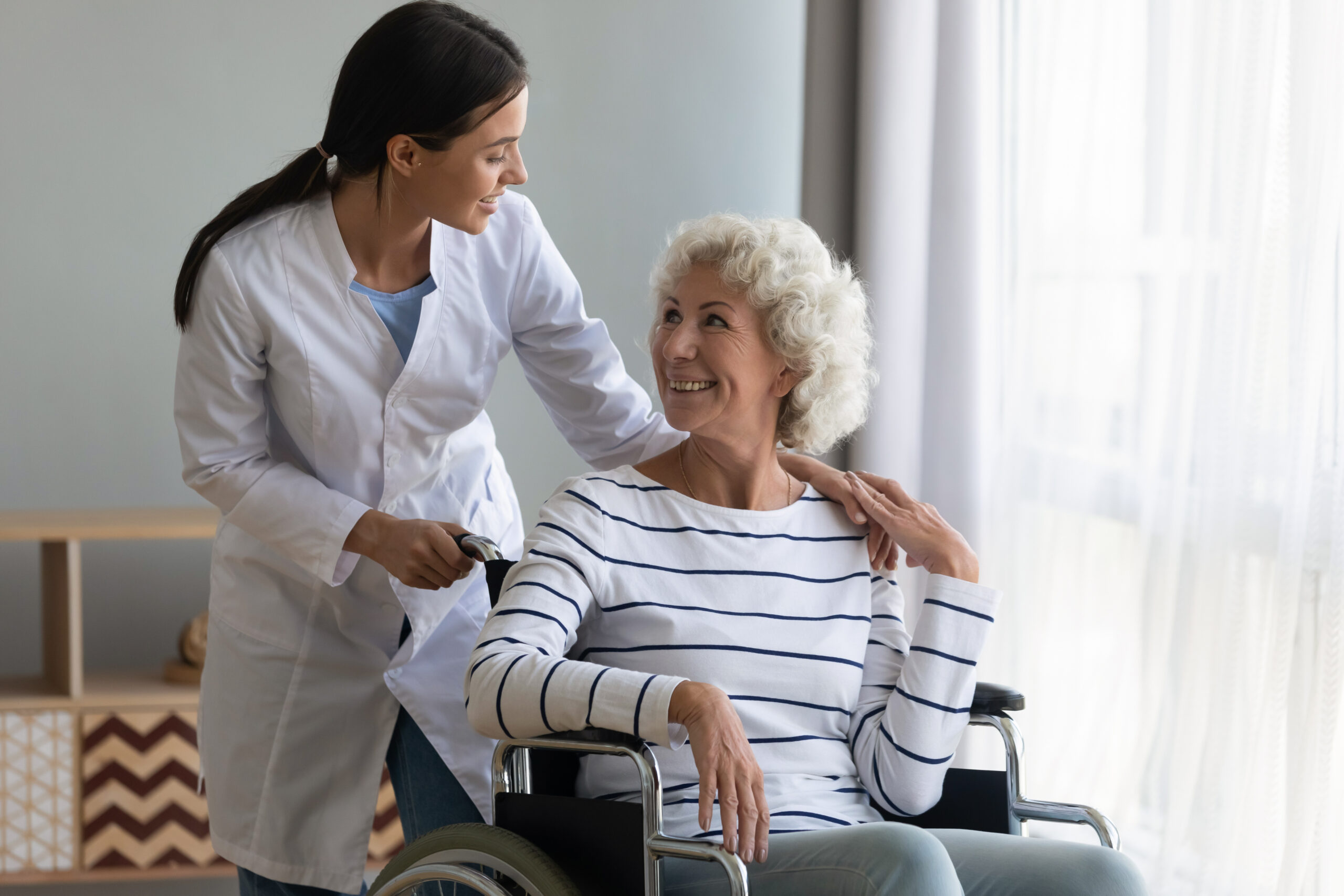 Therapist assisting wheelchair user during disability therapy at Atlanta Specialized Care in Atlanta and Alpharetta.